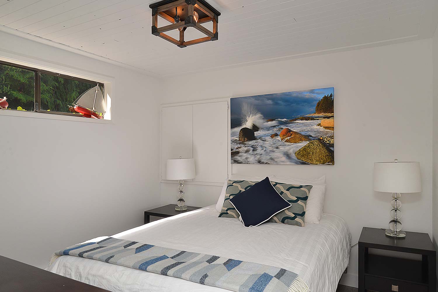 The bedroom in the cute cottage at John Henry’s Marina & Resort. This Mussel Beach Cottage is one bedroom and fully furnished.