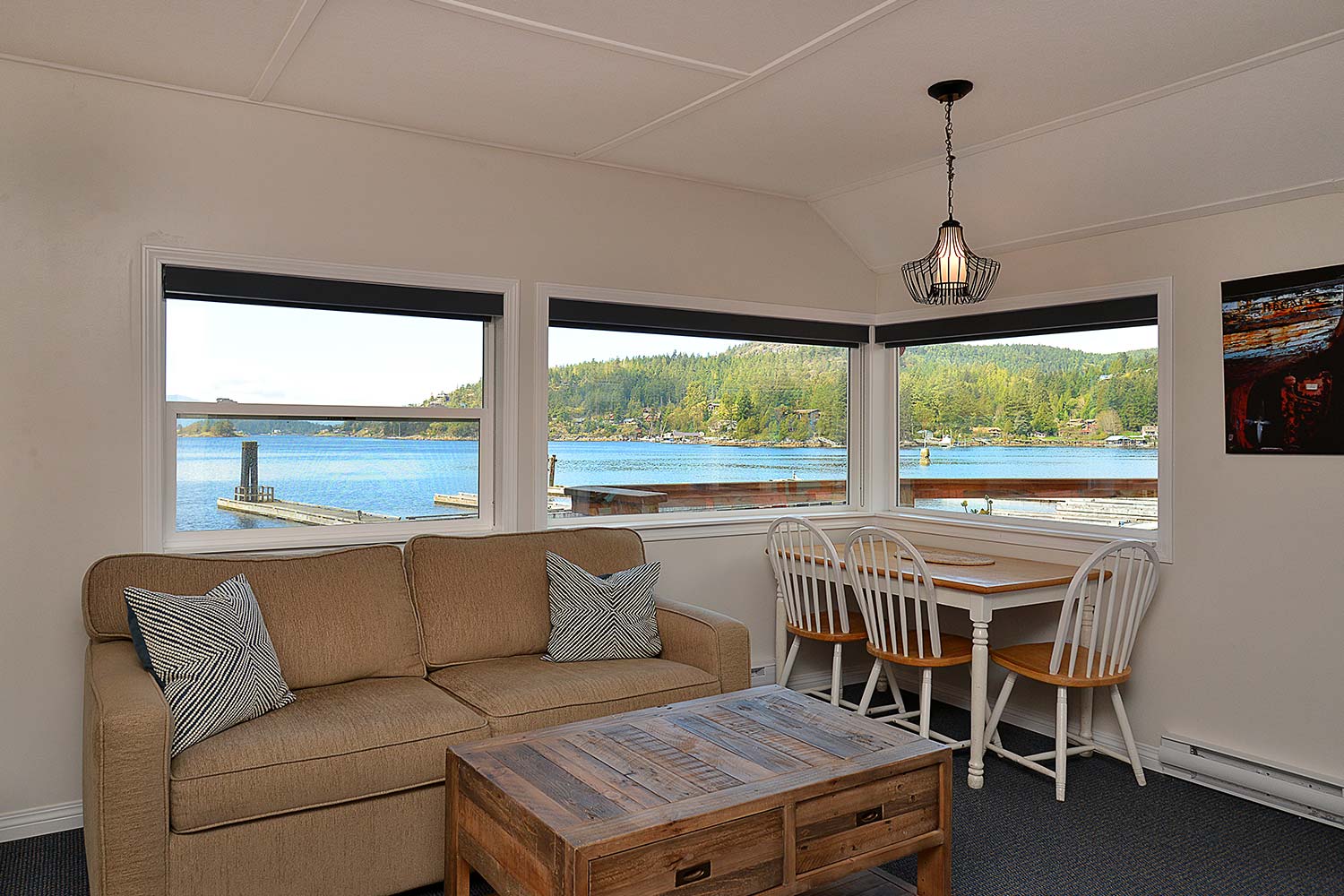 The Prawn Palace living room has a pull-out sofa bed and a coffee table, and features incredible views of Pender Harbour.